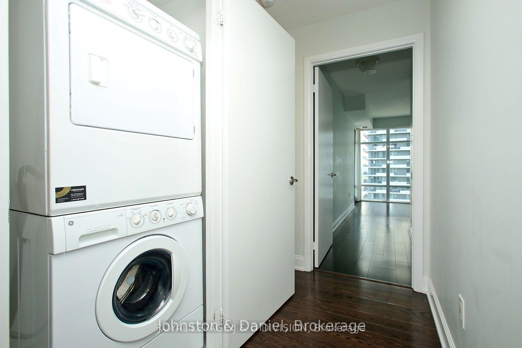 Separate laundry room with stacked washer dryer