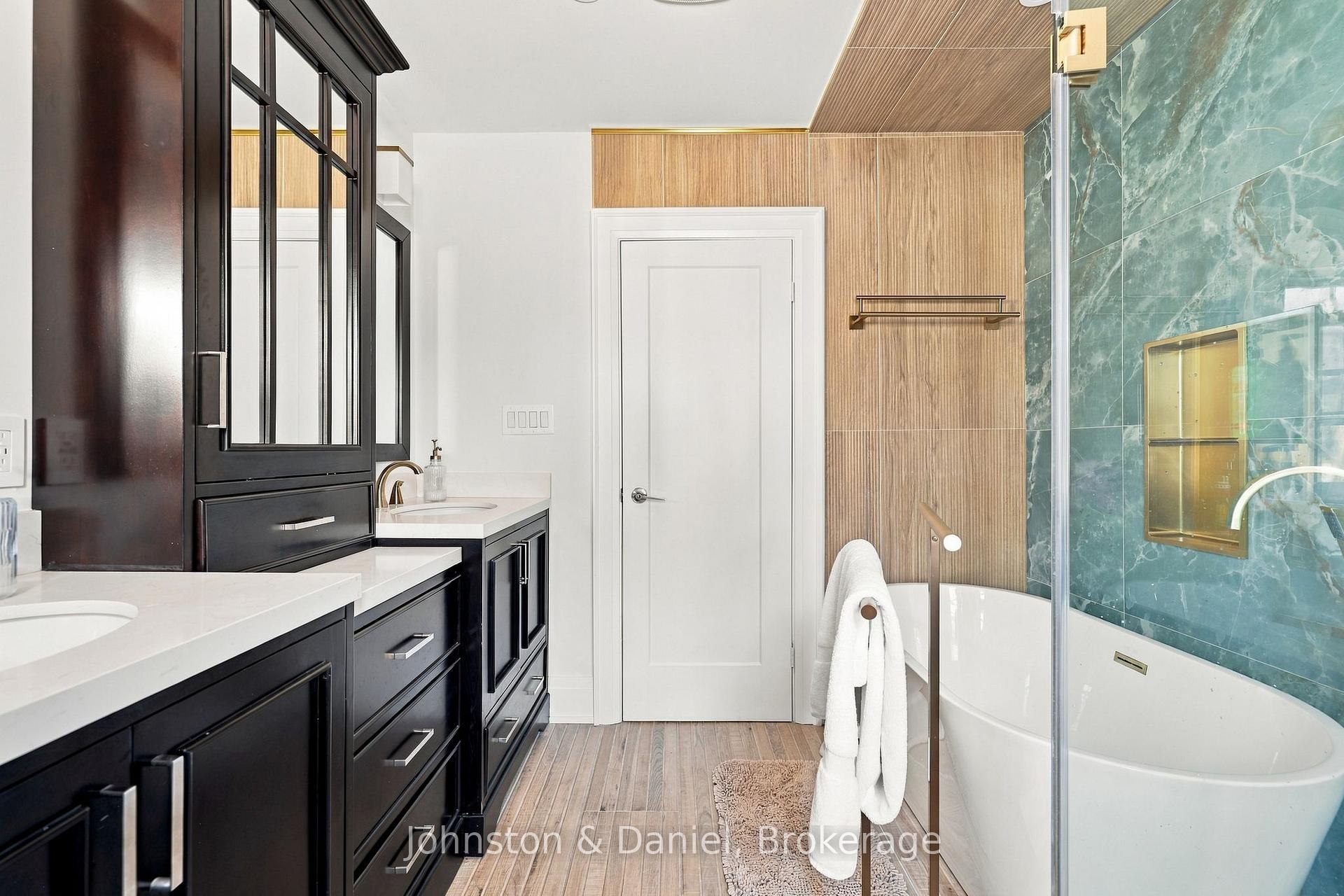 Soaker Tub beside glass-surround shower