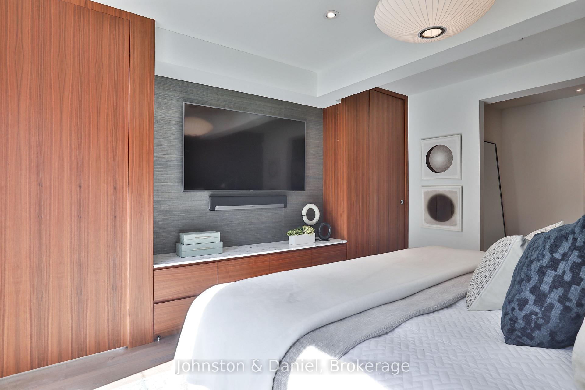 Wall of custom built-ins, concealed walk-in closet