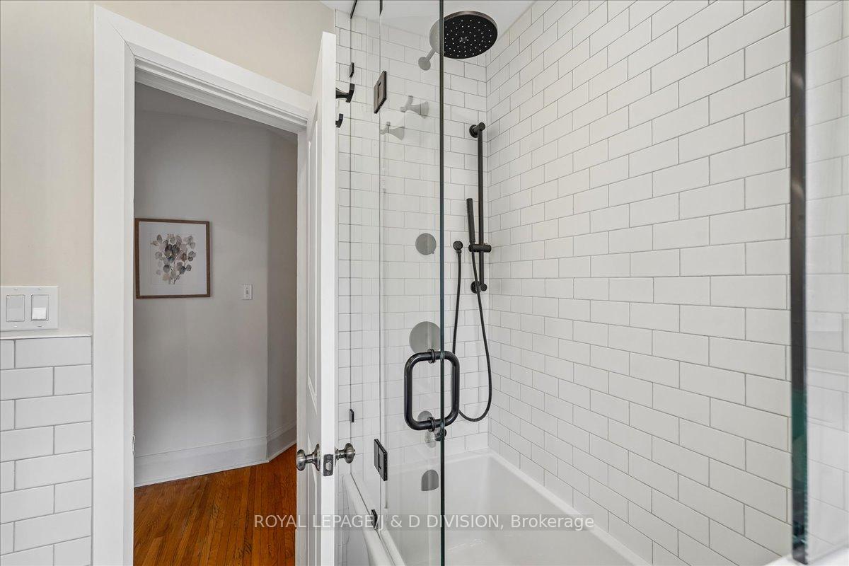 Glass door, black fixtures, white tiles