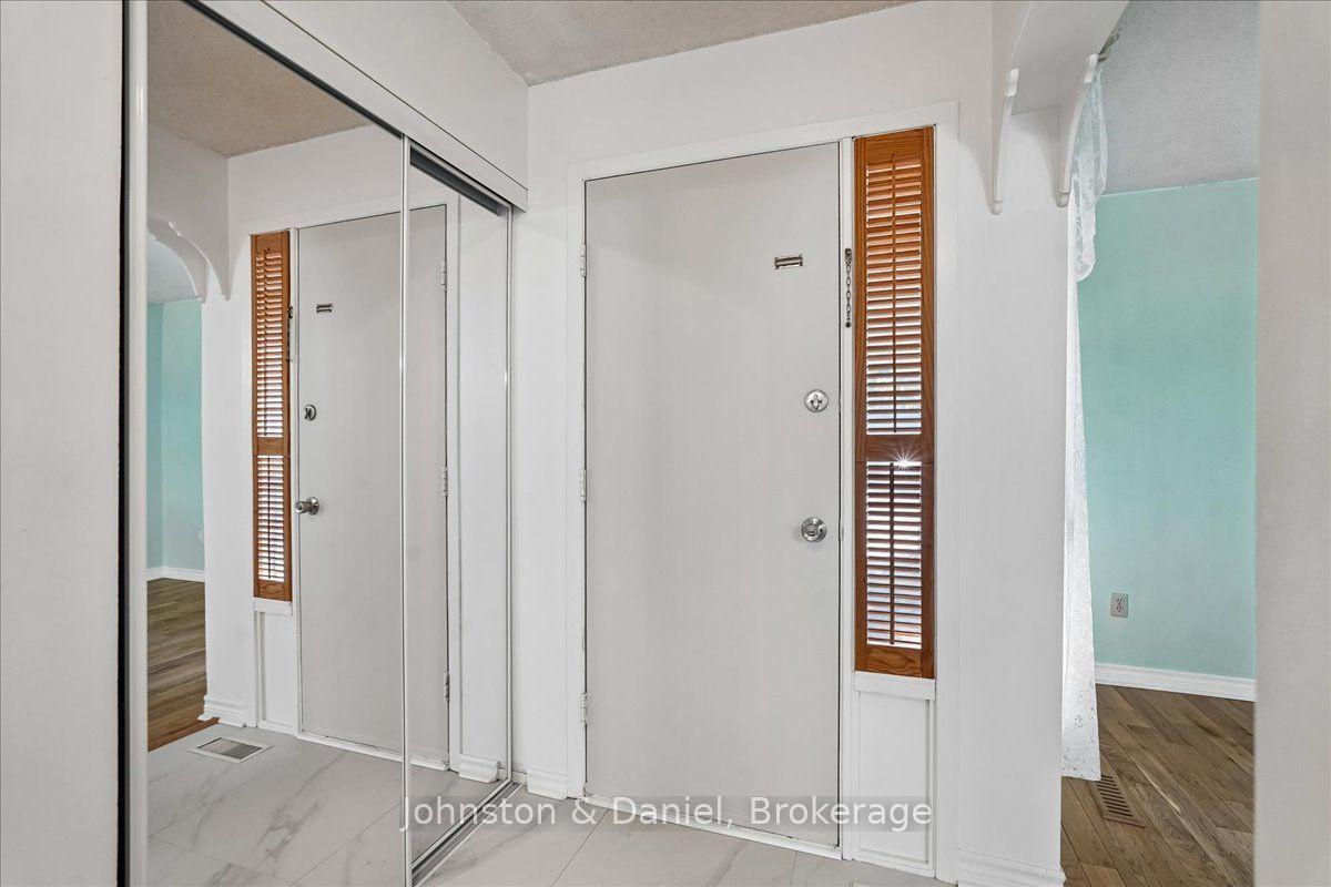 Double mirror closet doors in foyer, tile floor